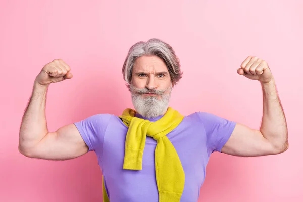 Photo of mature man show hands muscles sportive power strong sweater on shoulders isolated over pink color background — Stock Photo, Image