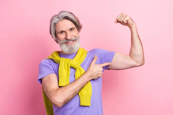 Photo of mature man happy smile point finger hands muscles sportive strong ad tied sweater isolated over pink color background — Stock Photo, Image