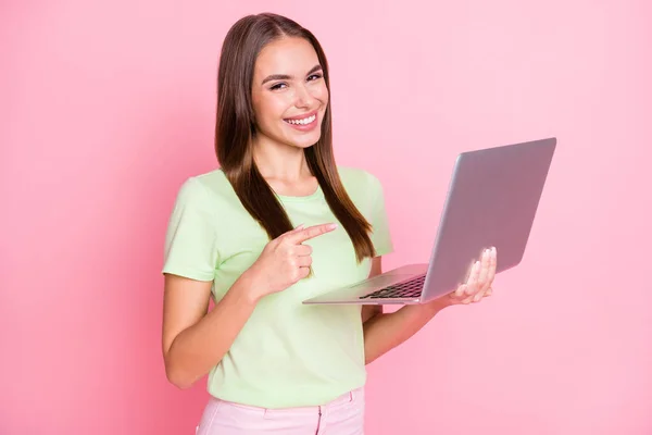 Portrait of charming positive lady indicate finger laptop good proposition isolated on pink color background — Stock Photo, Image