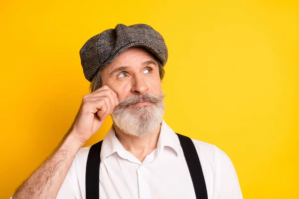 Photo of aged man hand touch cheek dream dreamy think look empty space isolated over yellow color background — Stock Photo, Image