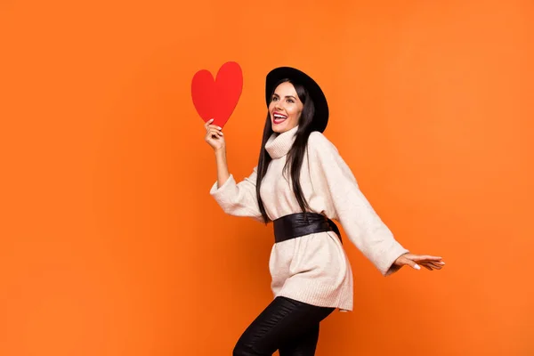 Fotografie mladé krásné usmívající se vzrušená dívka vzhled copyspace show valentine den dárek izolované na oranžové barvy pozadí — Stock fotografie