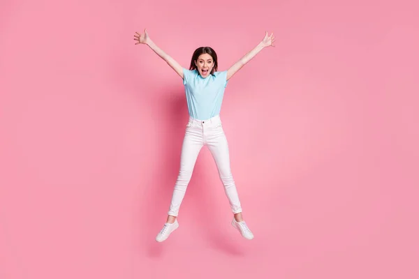 フルサイズ写真の驚くべきクレイジー女の子ジャンプ上げる手星着用gumshoes絶縁以上ピンク色の背景 — ストック写真