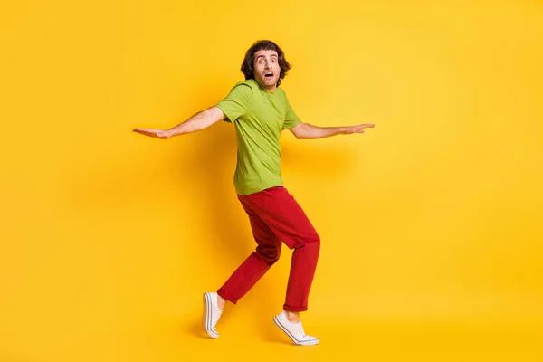 Full length body size photo of man going tiptoes looking nervous afraid thief escape isolated on bright yellow color background — Stock Photo, Image