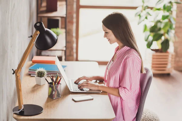 Perfil da foto lateral da jovem encantadora feliz sentar secretária escrever relatório de trabalho laptop home office dentro de casa — Fotografia de Stock