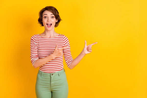 Foto de atractiva dama impresionada boca abierta indican dos dedos espacio vacío aislado sobre fondo de color amarillo brillante —  Fotos de Stock