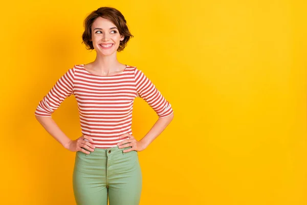 Retrato da pessoa satisfeita sorriso olhando espaço vazio colocar os braços na cintura isolada no fundo de cor amarela — Fotografia de Stock