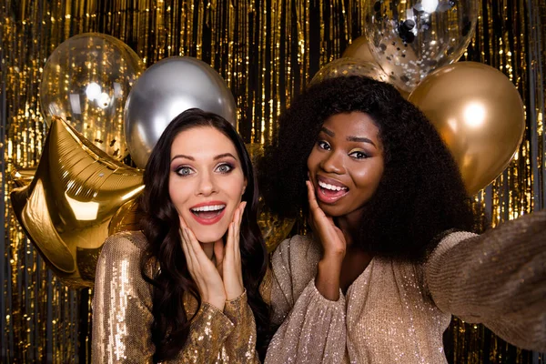 Photo of two festive ladies make selfie hold hands cheeks wear sequins dress balloons party isolated on shine bright background — Stock Photo, Image