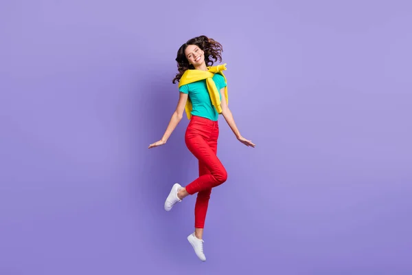 Foto in voller Länge von lustig charmant lockige junge Dame tragen Pullover Schultern springen hohe isolierte violette Farbe Hintergrund — Stockfoto