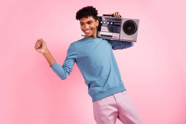 Photo of young man happy positive smile hold retro boombox enjoy music dance look empty space isolated over pastel color background — Stock Photo, Image