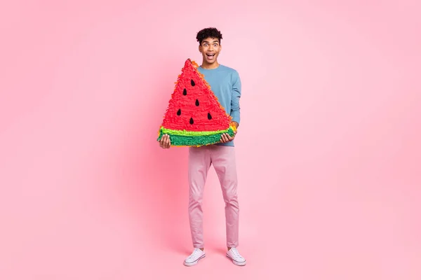 Foto de cuerpo completo del joven negro sonrisa feliz papel sorprendido piñata sandía aislado sobre fondo de color rosa — Foto de Stock