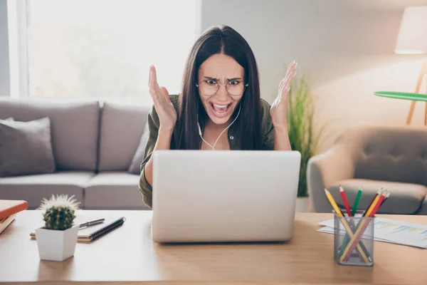 Photo of young angry furious stressed woman in glasses has video call speak tell explain problem trouble at home house — Stock fotografie