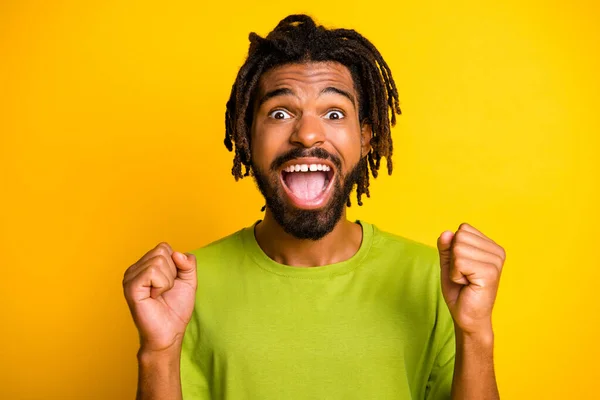 Photo of crazy dark skin guy win lottery raise fists shout isolated over bright yellow color background — Stock Photo, Image
