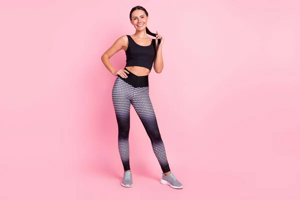 Photo of dreamy shiny young lady sportswear standing arm hair smiling isolated pink color background — Stock Photo, Image