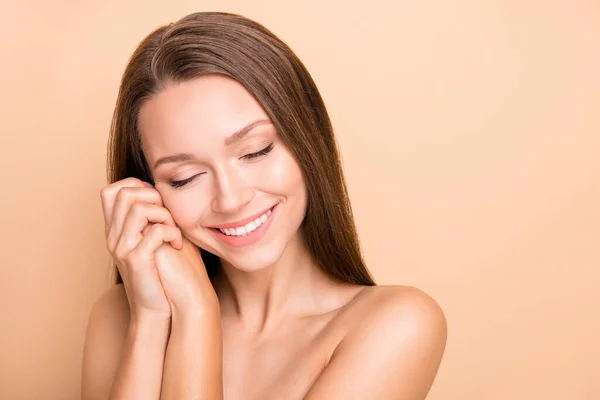 Photo of nice positive lady closed eyes arms palms folded near face no clothing isolated on beige color background — Stock Photo, Image