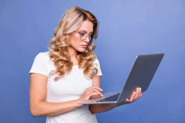 Portrait of attractive focused wavy-haired girl copywriter using laptop writing e-mail isolated over blue color background — Stock Photo, Image