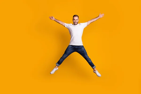 In voller Länge Körpergröße Ansicht der schönen unbeschwerten fröhlichen Kerl springen Spaß isoliert über helle gelbe Farbe Hintergrund — Stockfoto