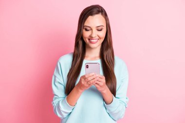 Photo of cheerful brown haired woman read sms message hold phone media isolated on pink color background clipart
