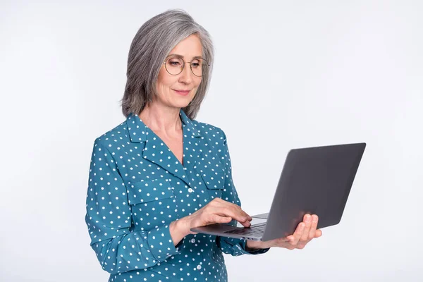 Photo portrait of senior lady typing using laptop working isolated on white color background — Stock Photo, Image