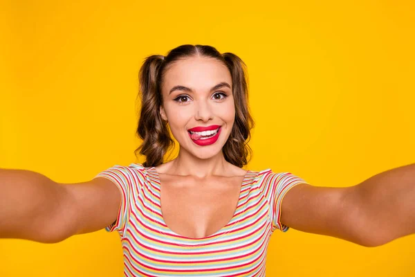 Portrait of young beautiful good mood smiling cheerful girl stick tongue out take selfie isolated on yellow color background — Stock Photo, Image