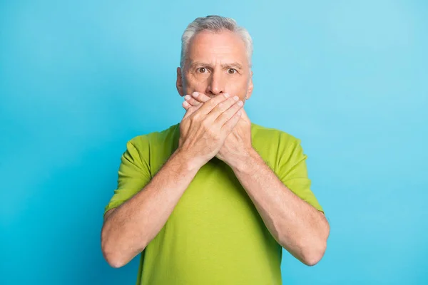 Portrait of attractive worried puzzled grey-haired man closing mouth mute oops isolated over bright blue color background — Stock Photo, Image