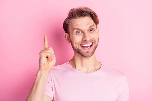 Портрет изумленного весельчака, указывающего пальцем на зубастую улыбку, смотрящего в камеру на розовом фоне — стоковое фото