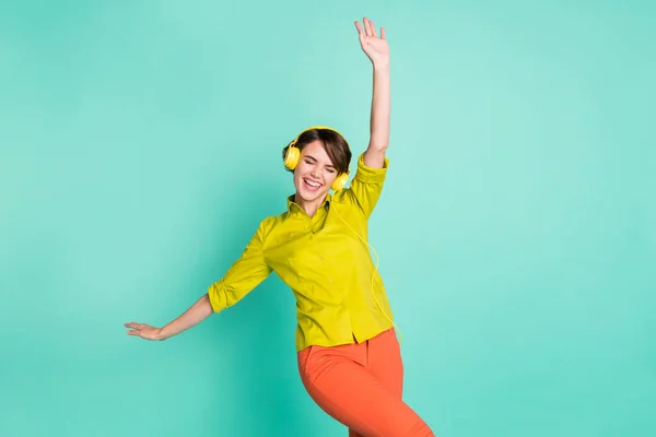 Photo portrait of overjoyed entertaining on weekend in headphones girl laughing isolated on vibrant turquoise color background — Stock Photo, Image