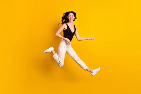 Full kropp profil sida foto av ung upphetsad flicka glad leende hoppa föreställa spela gitarr isolerad över gul färg bakgrund — Stockfoto
