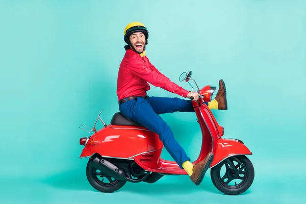 Foto sisi profil penuh dari brunette excited man ride motorbike speed isolated on teal color background — Stok Foto