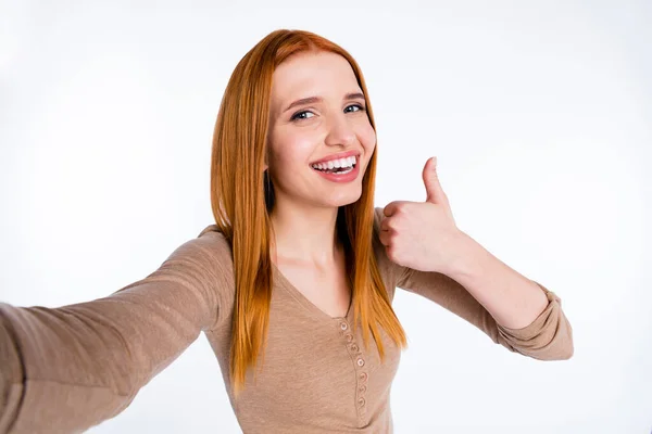 Photo of pretty adorable redhair woman beige shirt recording video showing thumb up smiling isolated white color background — Stock fotografie