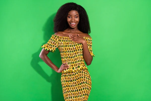 Photo of happy excited sweet smiling beautiful african woman hold hand chest hear good news isolated on green color background — Stock Photo, Image