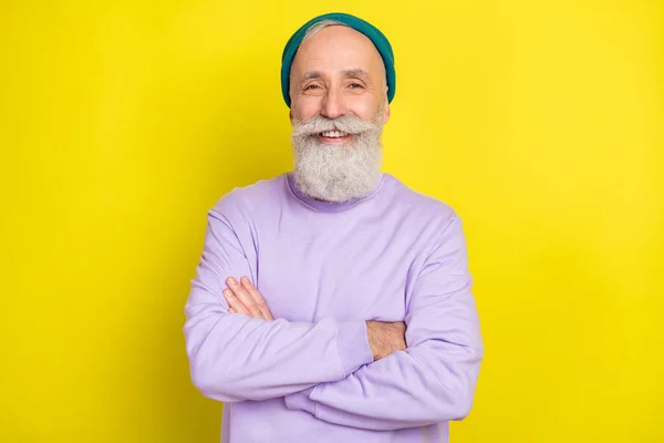 Photo portrait of aged man smiling happy with folded hands isolated vibrant yellow color background — Stock Photo, Image