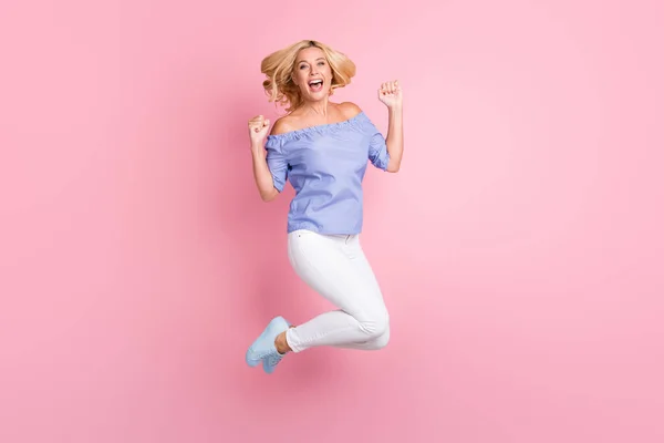 Full size profile photo of hooray blond curly hairdo lady jump wear top pants sneakers isolated on pastel pink color background — Stock Photo, Image