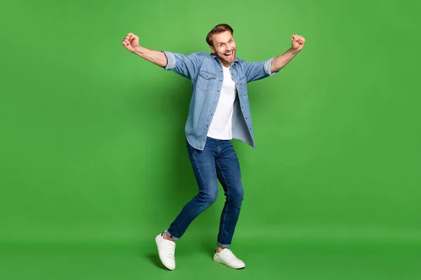 Full length body size photo of happy guy cheerful dancing at party isolated vibrant green color background — Stock Photo, Image