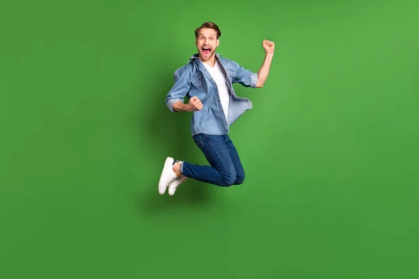 젊은 남자가 높이뛰기를 하는 전체 몸길이 사진 우승자처럼 밝은 녹색 배경을 분리 — 스톡 사진