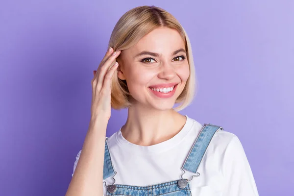 Foto de bonito optimista corto peinado rubio dama tacto pelo desgaste blanco camiseta aislada sobre fondo de color violeta —  Fotos de Stock