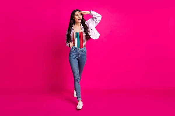 Full size foto di impressionato bruna bella signora andare a guardare indossare top giacca jeans scarpe da ginnastica isolato su sfondo di colore rosa — Foto Stock