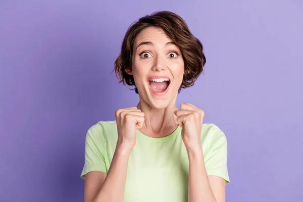 Portrait of lovely cheerful amazed brown-haired girl celebrating great luck isolated over violet color background — Stock Photo, Image