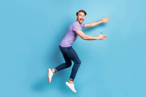 Full body profile photo of astonished crazy person open mouth arms wait catch isolated on blue color background