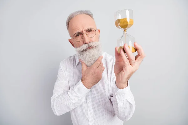 Photo of think grey hair old man boss hold watch wear spectacles white shirt isolated on grey color background