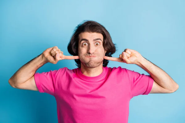 Photo of funky childish arab guy hold breathe for bet mouth full air press fingers cheeks wear casual pink t-shirt isolated blue bright color background — Stock Photo, Image