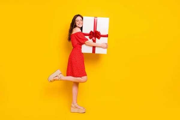 Full body profile photo of pretty cheerful person closed eyes arms hold big giftbox isolated on yellow color background — Stock Photo, Image
