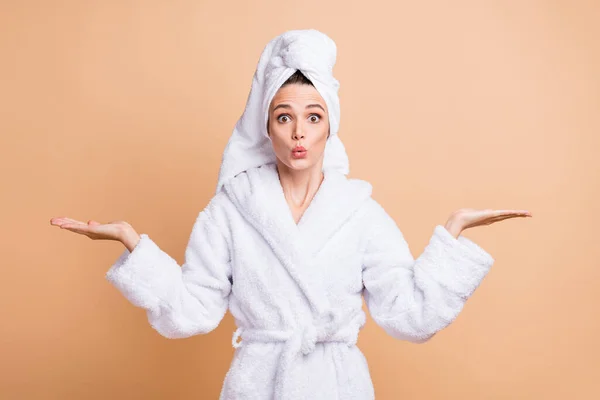 Porträt der schönen erstaunt Mädchen tragen Bademantel hält auf zwei Handflächen kopieren Raum Variante Option isoliert über beige Pastellfarbe Hintergrund — Stockfoto