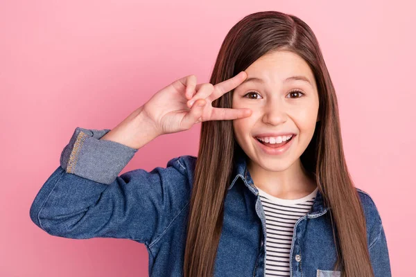 Foto portret van klein meisje tonen v-teken gebaar glimlachen dolblij geïsoleerd op pastel roze kleur achtergrond — Stockfoto