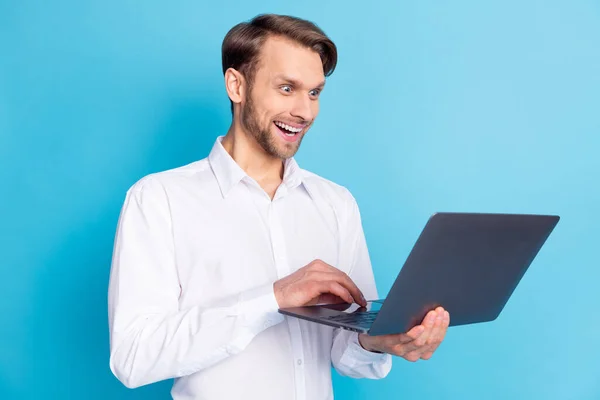 Zdjęcie zdumiony szczęśliwy młody biznesmen wygląd laptop wiadomości izolowane na pastelowym tle niebieski kolor — Zdjęcie stockowe