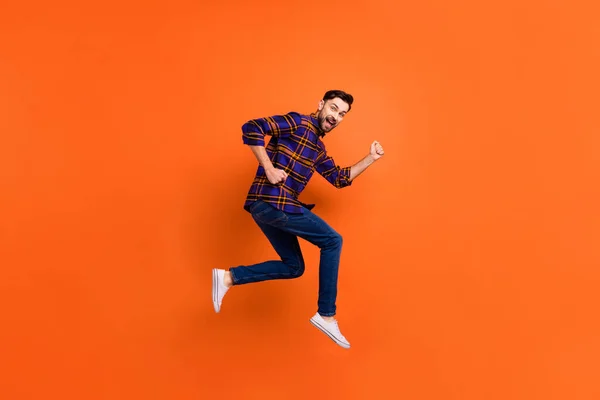 Full length portrait of cheerful excited handsome guy running open mouth isolated on orange color background — Stock Photo, Image