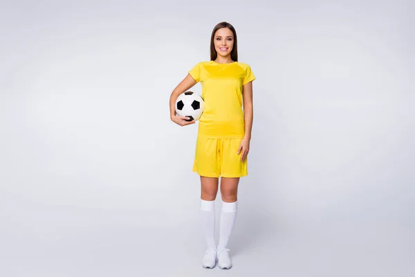 Full body photo of sporty shapes captain lady player soccer women team hold leather ball wear yellow football uniform t-shirt shorts boots knee socks isolated white color background — Zdjęcie stockowe