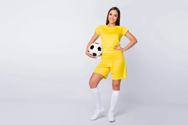 Full size photo of fit figure captain lady confident player soccer women team hold leather ball wear yellow football uniform t-shirt shorts boots knee socks isolated white color background — Zdjęcie stockowe