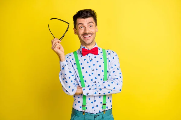 Portrait of attractive cheerful guy showman mc wearing print shirt isolated over bright yellow color background — Stockfoto