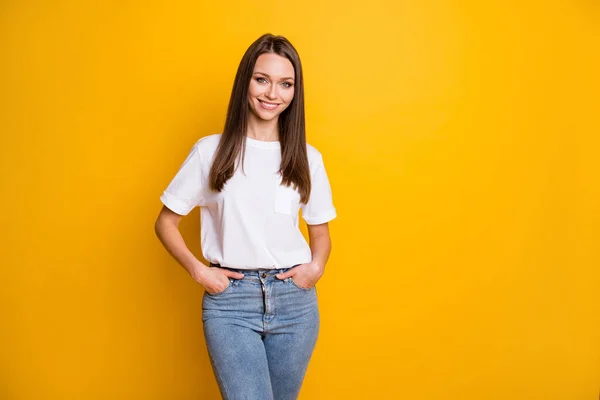 Portrait photo de fille avec deux mains dans des poches isolées sur fond jaune vif avec espace vide — Photo