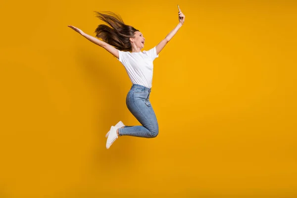 Volledige lengte lichaam grootte foto van vrouw het nemen van selfie gooien haar springen lachen geïsoleerd op levendige gele kleur achtergrond — Stockfoto